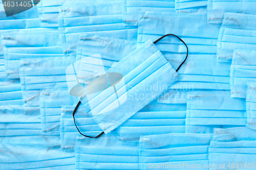 Image of Blue medical background with protective face masks. Top view.