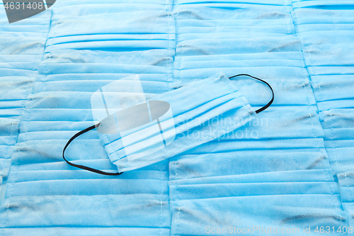 Image of Medical mask on the same blue background from protective masks. 