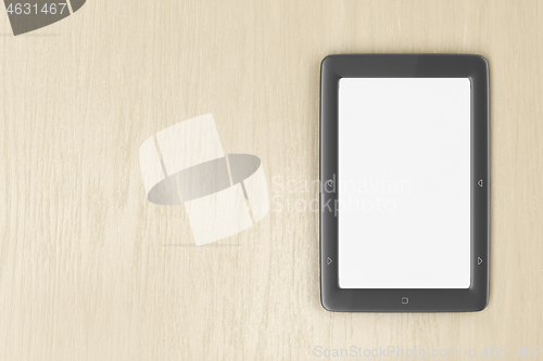 Image of E-book reader on wood desk