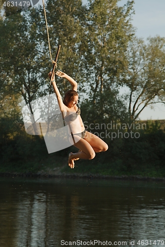 Image of Rope swing river jump