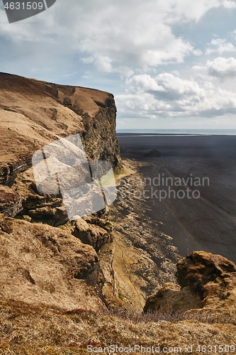 Image of Icelandic landscape with cliffs and black sand