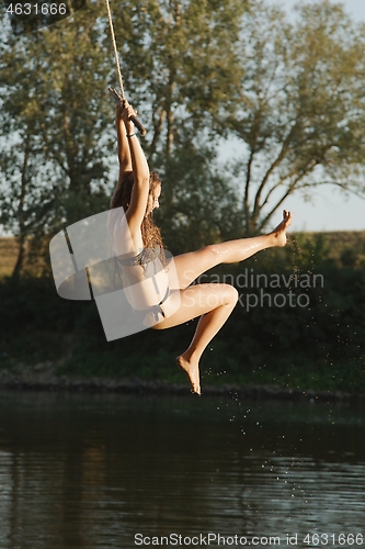 Image of Rope swing river jump