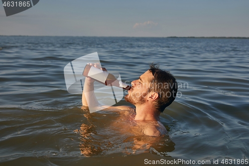 Image of Summer beach drinking beer and swimming