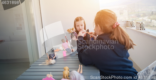 Image of little girls playing with dolls