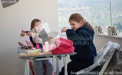 Image of little girls playing with dolls