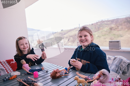 Image of little girls playing with dolls