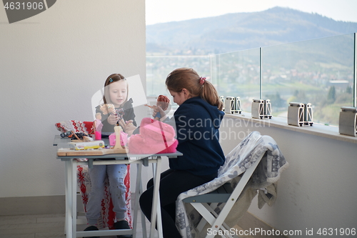 Image of little girls playing with dolls