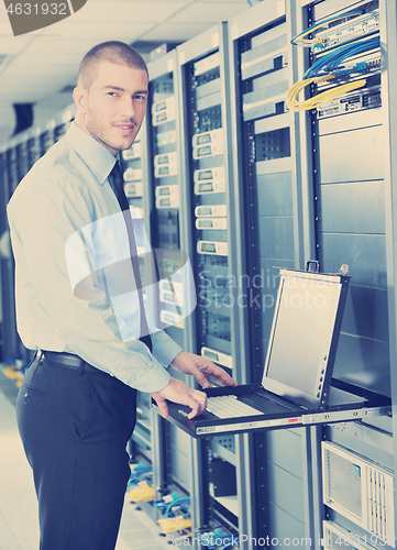 Image of young it engeneer in datacenter server room