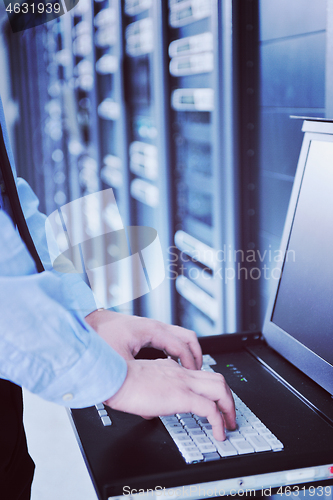 Image of young it engeneer in datacenter server room