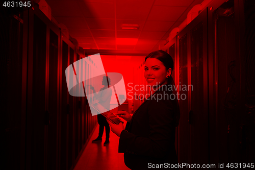 Image of Female engineer working on a tablet computer in server room