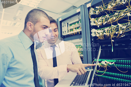 Image of it engineers in network server room