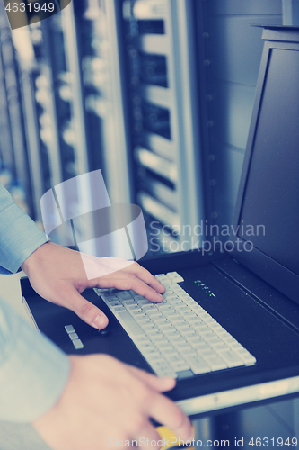 Image of young it engeneer in datacenter server room