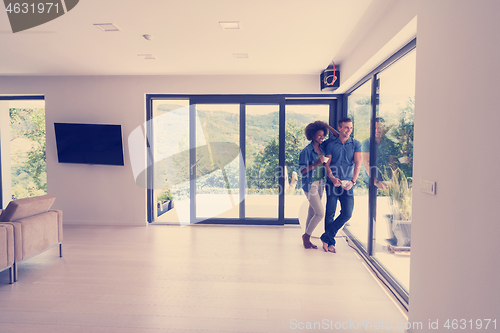 Image of romantic happy young couple relax at modern home indoors