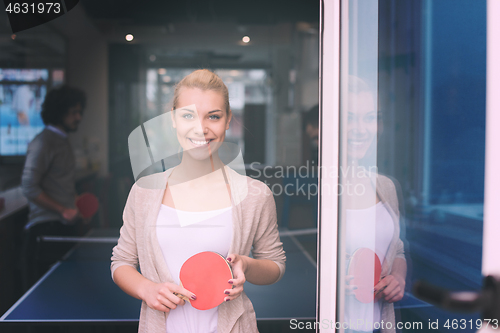 Image of startup business team playing ping pong tennis