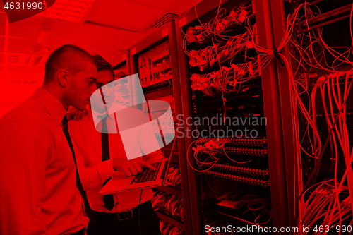 Image of it engineers in network server room