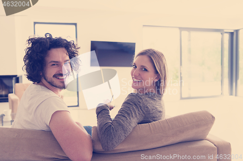 Image of Rear view of couple watching television