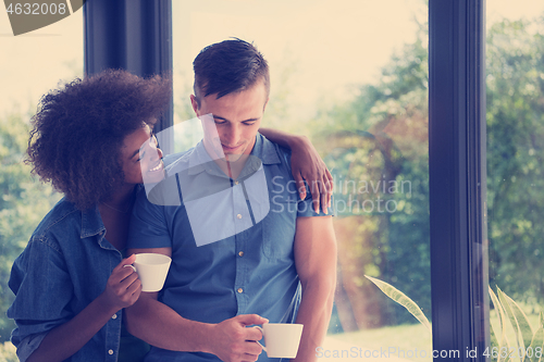 Image of romantic happy young couple relax at modern home indoors