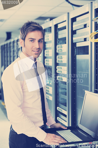 Image of young it engeneer in datacenter server room