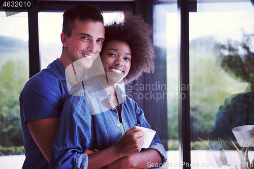 Image of romantic happy young couple relax at modern home indoors