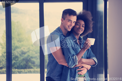 Image of romantic happy young couple relax at modern home indoors