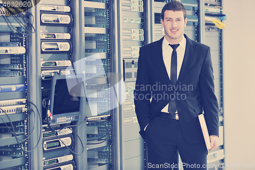 Image of young engeneer in datacenter server room