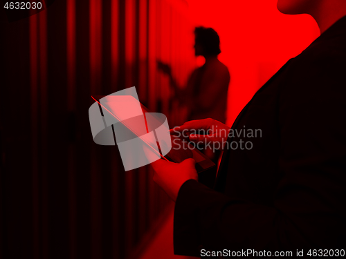 Image of Female engineer working on a tablet computer in server room