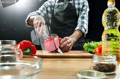 Image of Preparing salad. Female chef cutting fresh vegetables. Cooking process. Selective focus