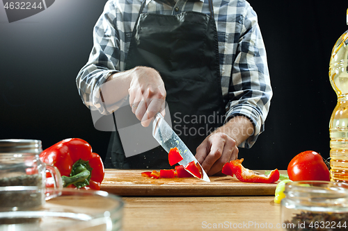 Image of Preparing salad. Female chef cutting fresh vegetables. Cooking process. Selective focus