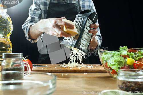 Image of Preparing salad. Female chef cutting fresh vegetables. Cooking process. Selective focus