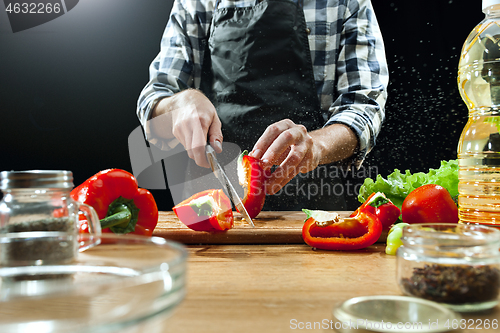 Image of Preparing salad. Female chef cutting fresh vegetables. Cooking process. Selective focus