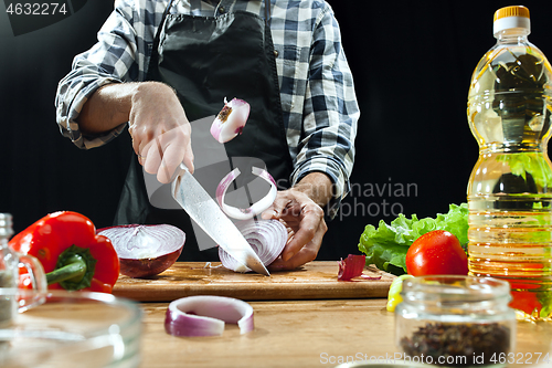 Image of Preparing salad. Female chef cutting fresh vegetables. Cooking process. Selective focus