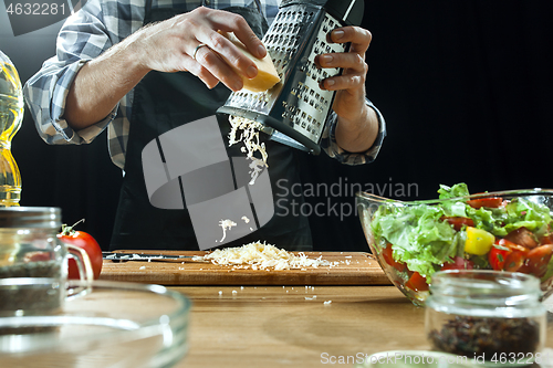 Image of Preparing salad. Female chef cutting fresh vegetables. Cooking process. Selective focus