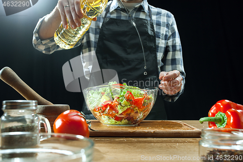 Image of Preparing salad. Female chef cutting fresh vegetables. Cooking process. Selective focus