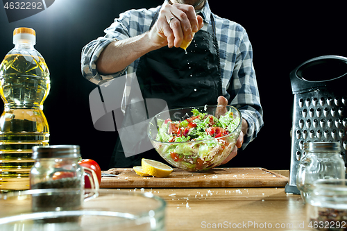 Image of Preparing salad. Female chef cutting fresh vegetables. Cooking process. Selective focus