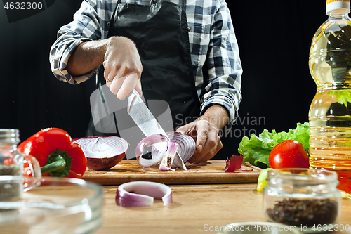 Image of Preparing salad. Female chef cutting fresh vegetables. Cooking process. Selective focus