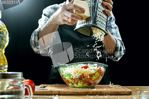 Image of Preparing salad. Female chef cutting fresh vegetables. Cooking process. Selective focus