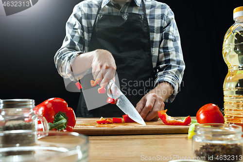 Image of Preparing salad. Female chef cutting fresh vegetables. Cooking process. Selective focus