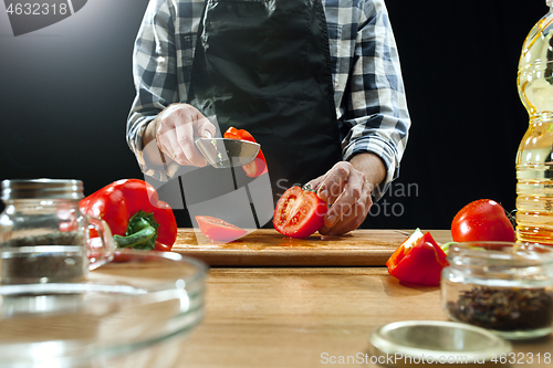 Image of Preparing salad. Female chef cutting fresh vegetables. Cooking process. Selective focus