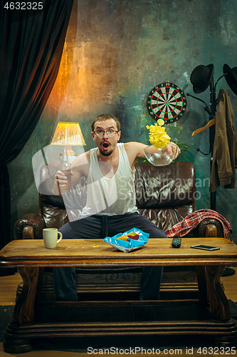 Image of The crazy football fan watching soccer game on television