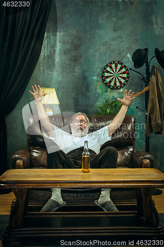 Image of The crazy football fan watching soccer game on television