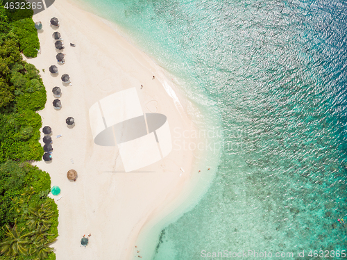 Image of Aerial drone view of picture perfect beach and turquoise lagoon on small tropical island on Maldives