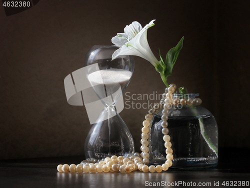 Image of Alstroemeria flower and sandglass