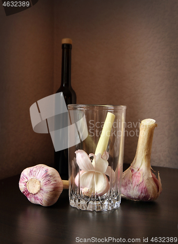 Image of Three garlic bulbs and bottle