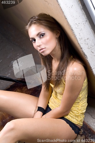 Image of the sexy young beauty woman sitting near wall 2