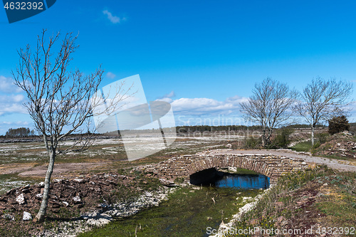 Image of Old limestone stonebridge in a plain landscape