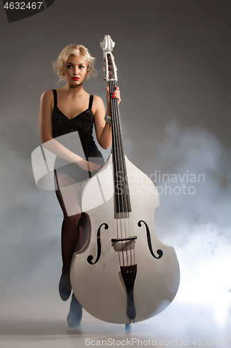 Image of Young Woman In Lingerie With A Double Bass