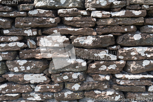 Image of Weathered dry stone wall background