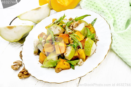 Image of Salad of pumpkin and pear in plate on light board