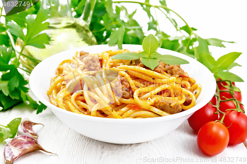 Image of Spaghetti with bolognese in plate on wooden board