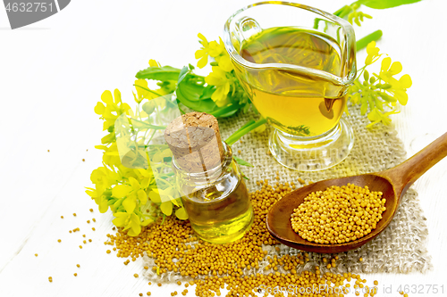Image of Oil mustard in jars and gravy boat on light board